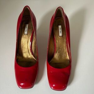 Size 35 1/2 Miu Miu cherry red patent leather pumps.